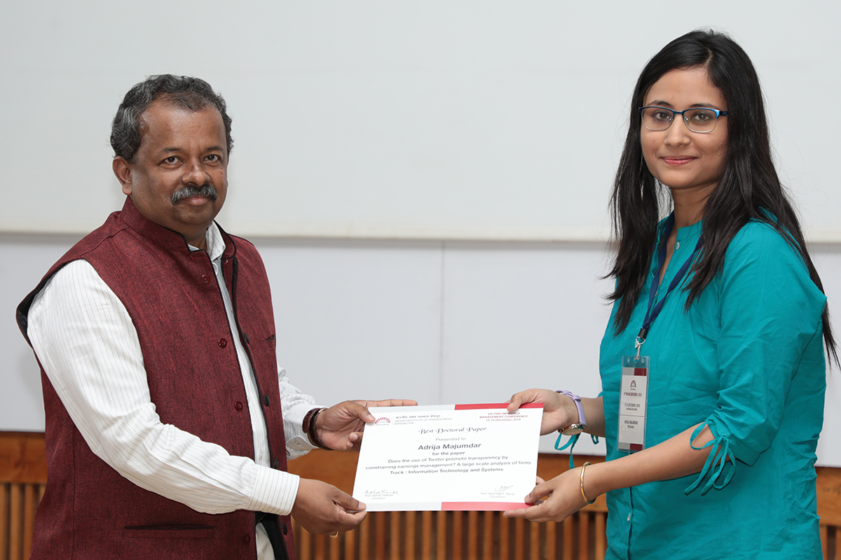 Adrija Majumdar receives the Best Doctoral Paper award from Prof. Gopal Naik, Dean Faculty, IIMB, for her paper, co-written with Indranil Bose and Alvin Leung, ‘Does the Use of Twitter Promote Transparency by Constraining Earnings Management? A Large-scale Analysis of Firms’ at the 6th Pan IIM Conference hosted by IIMB.