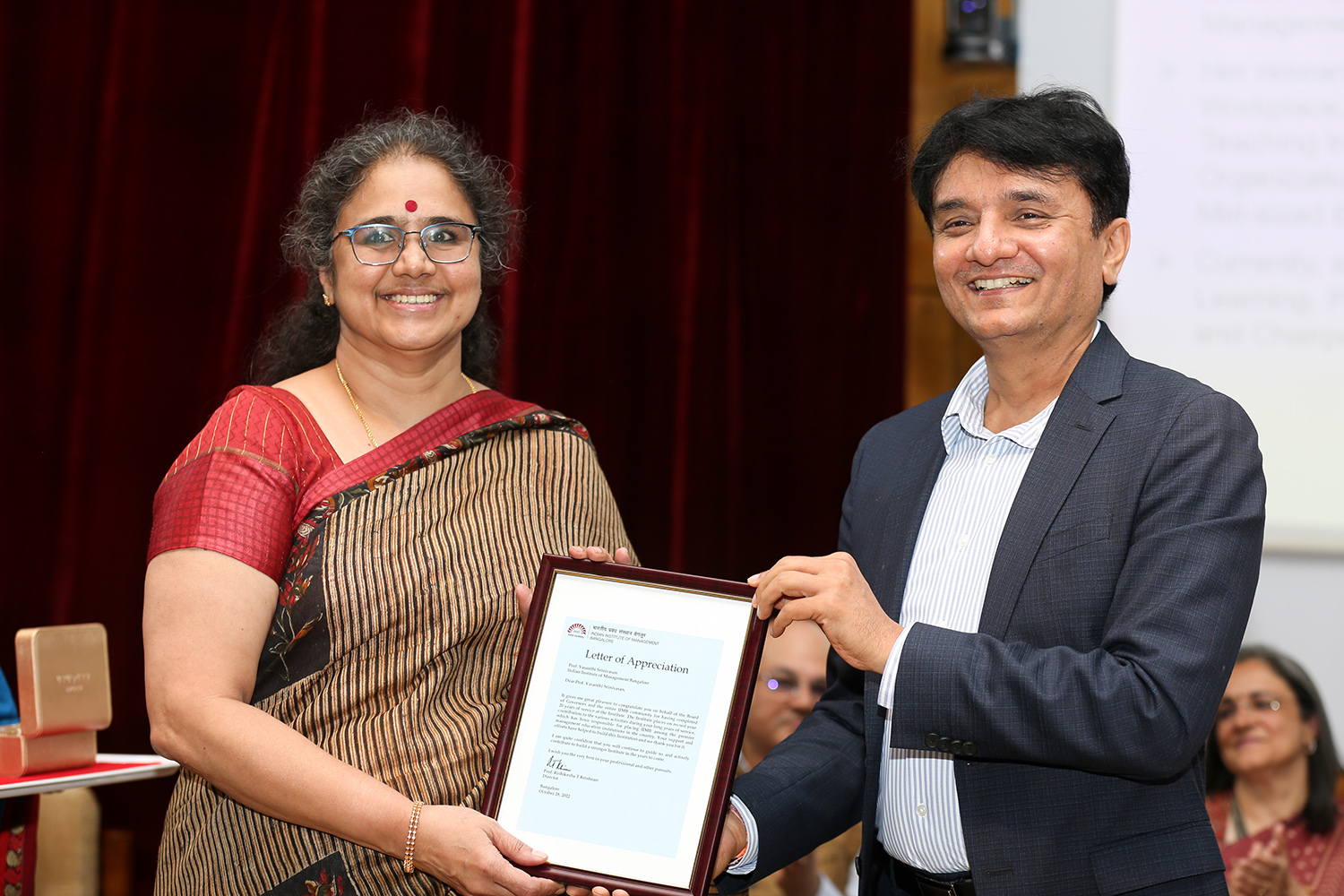 Professor Vasanthi Srinivasan, faculty in the Organizational Behavior &amp; Human Resources Management area, receives the award for 20 years of service from Mr MD Ranganath, Member of the Board of Governors, IIMB, during the institute’s 49th Foundation Day celebrations.