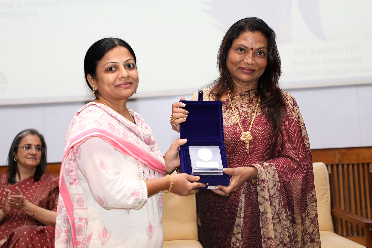 Ms Savithri HD, Senior Manager, Accounts Department, receives the award for 10 years of service from Ms. Kalpana Saroj, Member of the Board of Governors, IIMB during the institute’s 49th Foundation Day celebrations.