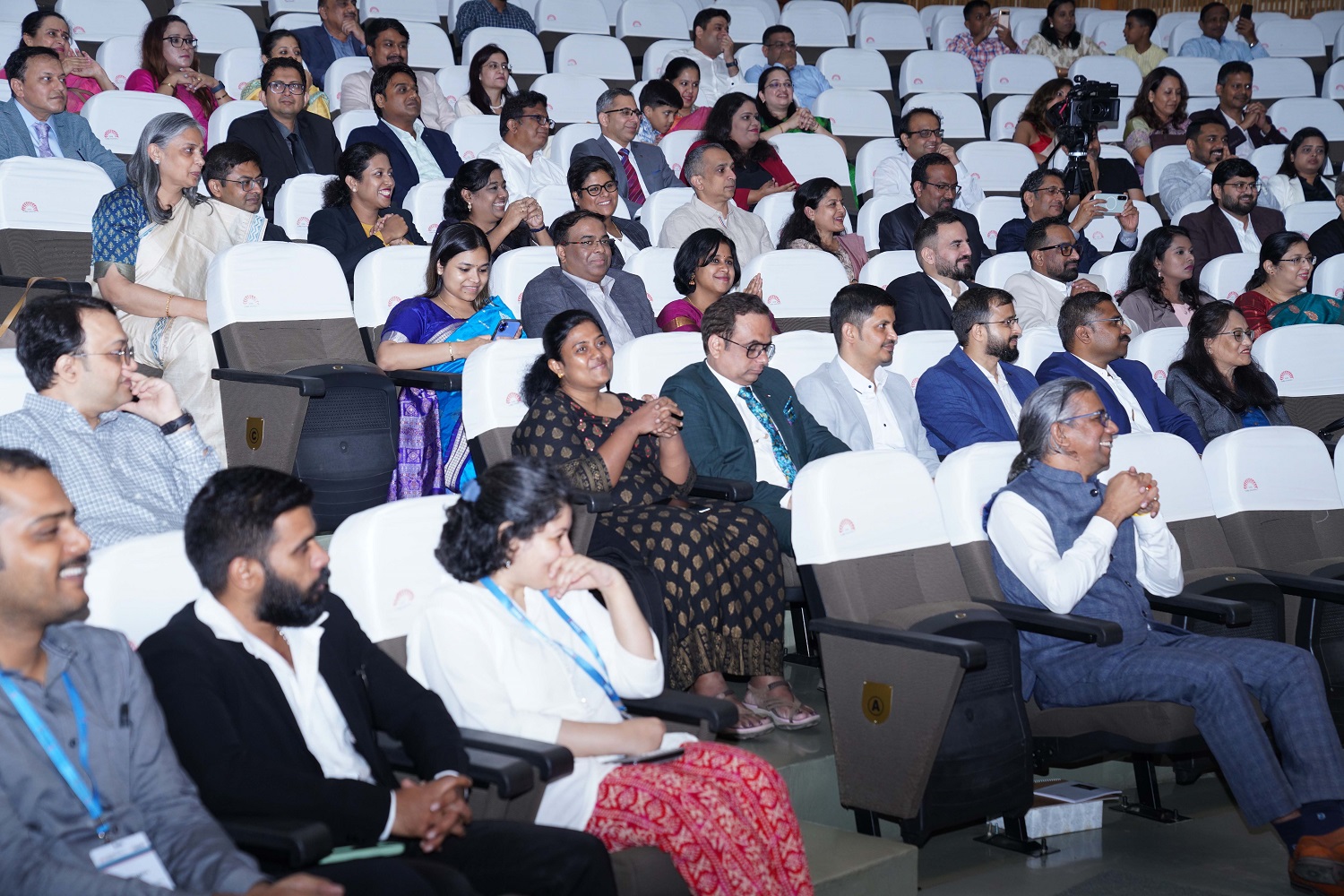 A gathering of doctors, clinicians, and healthcare workers, accompanied by their families, during the ceremony.