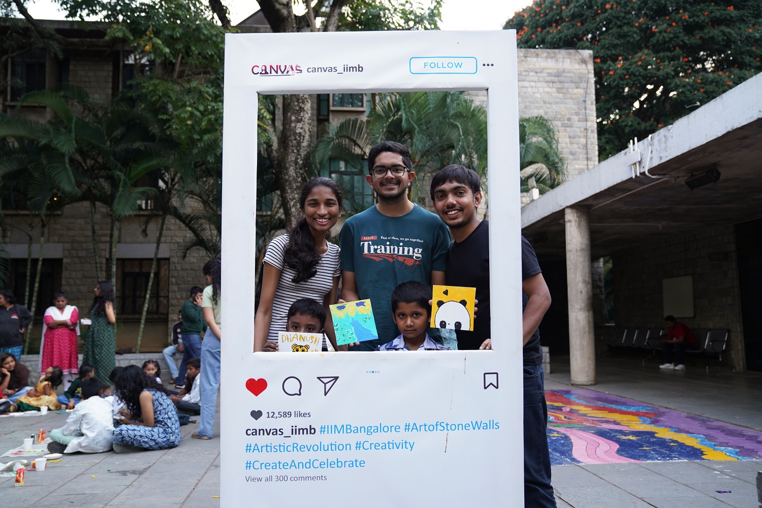 Students and children pose with their colourful creations during the Canvas Art Workshop.