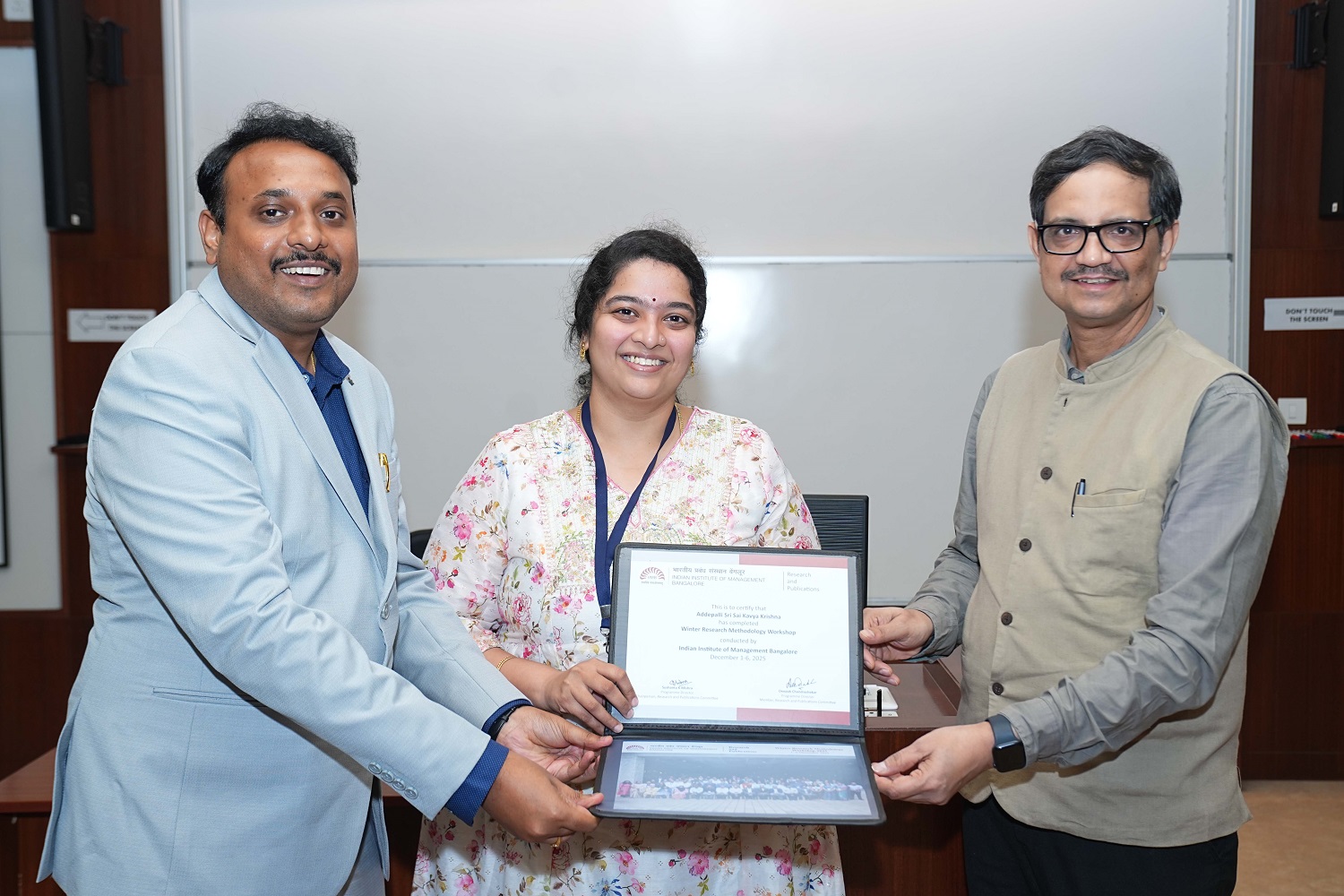 A scholar receiving their certificate at the valedictory of the Winter Research Methodology Workshop 2025