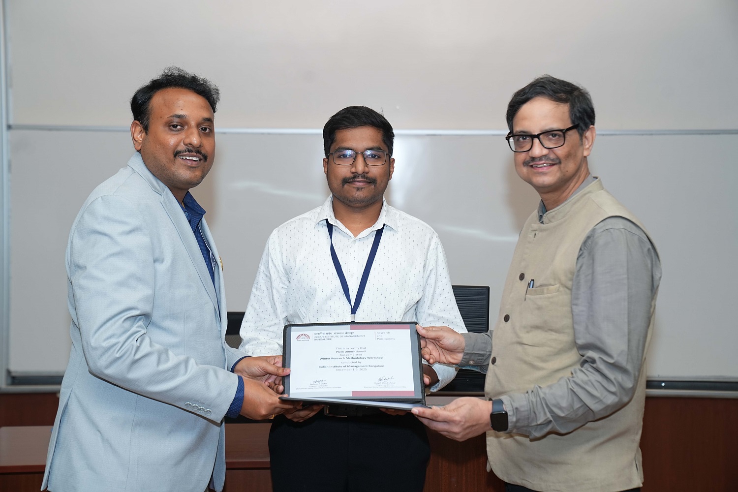 A scholar receiving their certificate at the valedictory of the Winter Research Methodology Workshop 2025