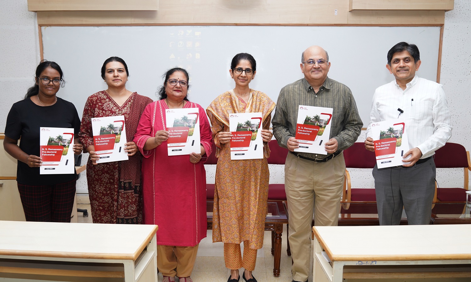 (L-R): Prof. Reshma, IIMB Young Faculty Research Chair; Khushboo Chhangani, Office of Disability Services; Kavitha Kumar, Head of Communication; Prof. Mukta Kulkarni, Dean of Programmes; Prof. Rishikesha T Krishnan, Director, IIMB; and Prof. Anil B Suraj, Chairperson of the NSR Pre-doc Fellowship launching the NSR Pre-doc Manual of Policies and Procedures.
