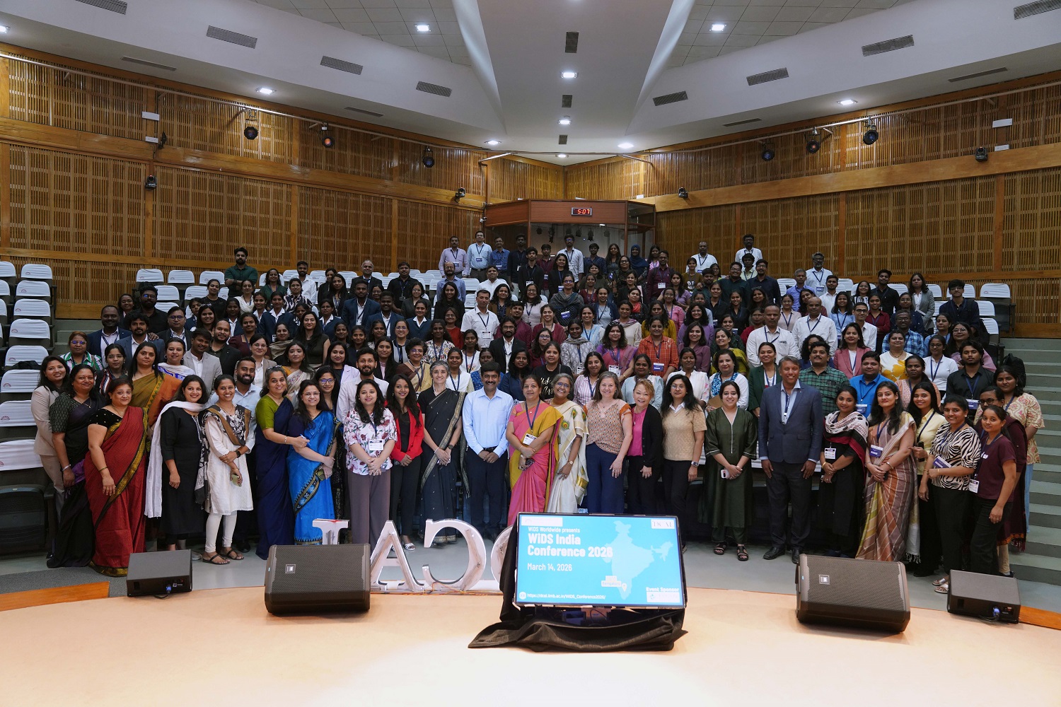 A group photograph of speakers, faculty members, participants, and students of the Business Analytics & Artificial Intelligence Programme at IIM Bangalore during the 8th annual WiDS India Conference 2026, organised by DCAL.