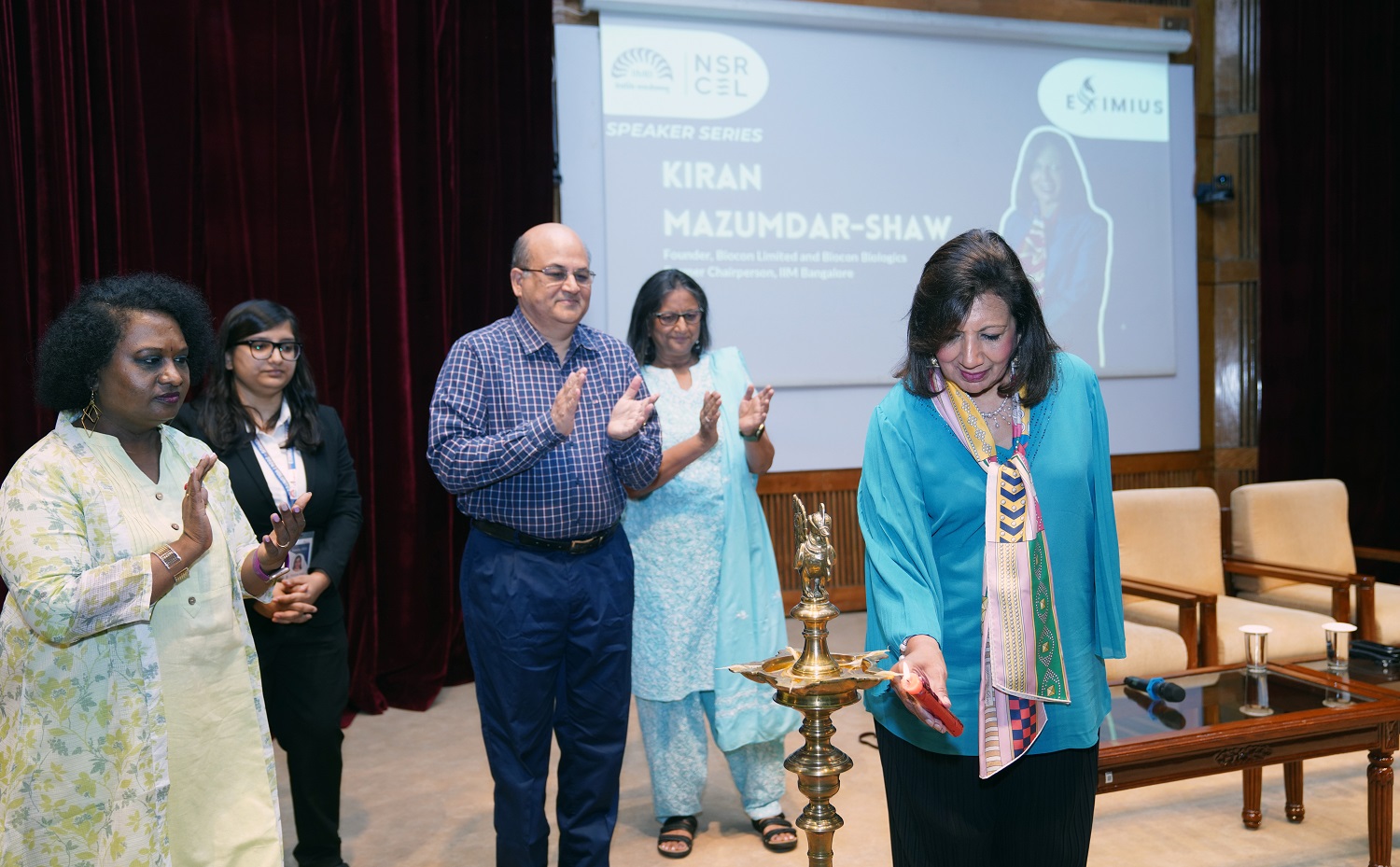 Dr. Kiran Mazumdar Shaw, Chairperson and Managing Director of Biocon, lights the ceremonial lamp at the inauguration of Eximius 2024, the 17th annual entrepreneurship summit, jointly organized by PGP and PGP Business Analytics students and NSRCEL on 6th July 2024. 