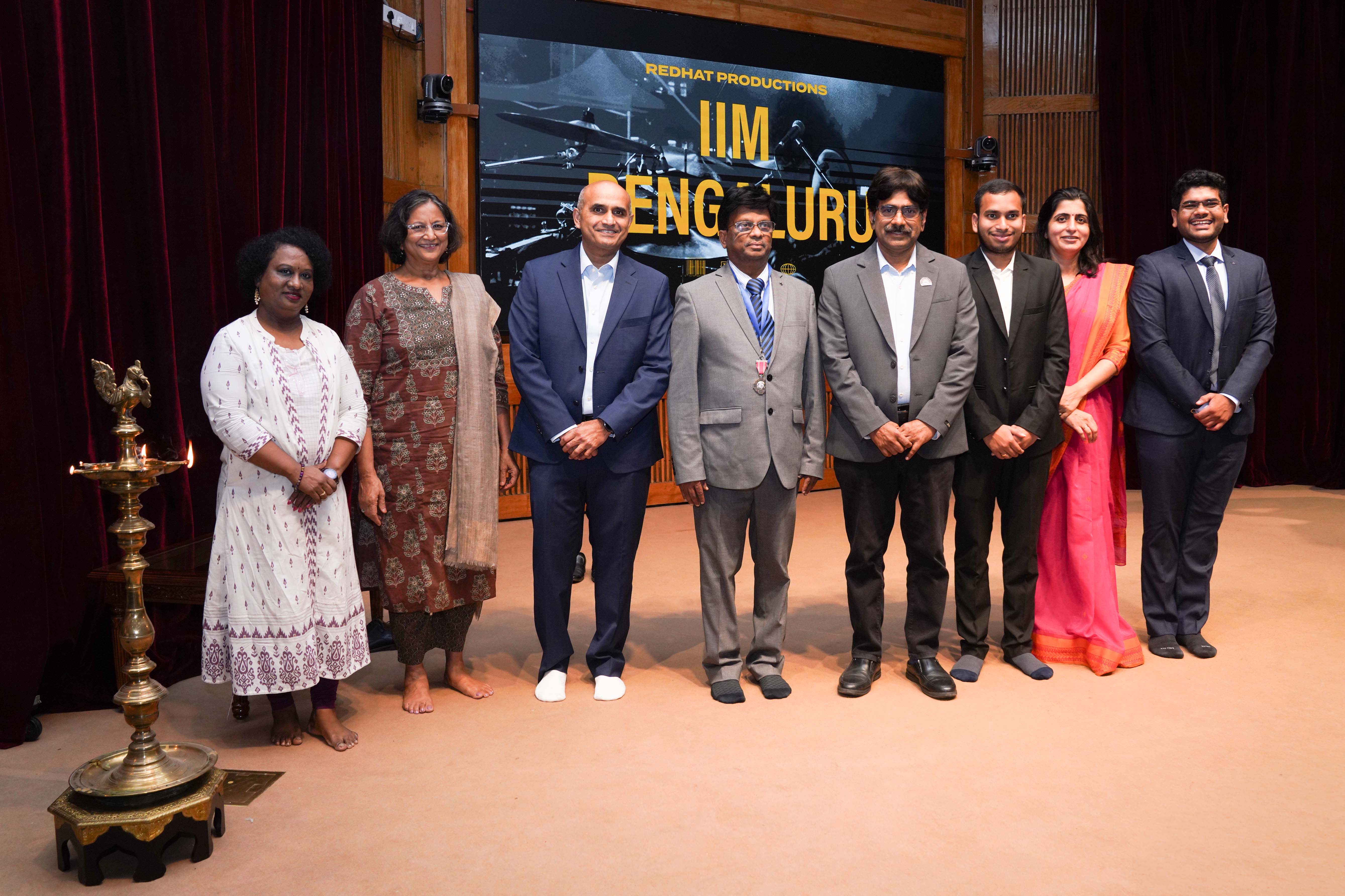 (L-R): Komala Devi M, Administrative Officer, Hostel, IIMB; Prof. Rajluxmi V Murthy, Chairperson, Student Welfare, IIMB; Prasad Gantasai, Senior Vice President and CHRO, Wipro; Dr. John Ebnezar, orthopaedic surgeon; Prof. Dinesh Kumar, Director-in-charge, IIMB; a member of the Student Affairs Council (SAC) IIMB; Prof. Manaswini Bhalla, Chairperson, PGP & PGPBA, IIMB; and Yash Mehnawat, Head, VENIX 2026, light the ceremonial lamp at the inauguration of VENIX 2026, IIM Bangalore.