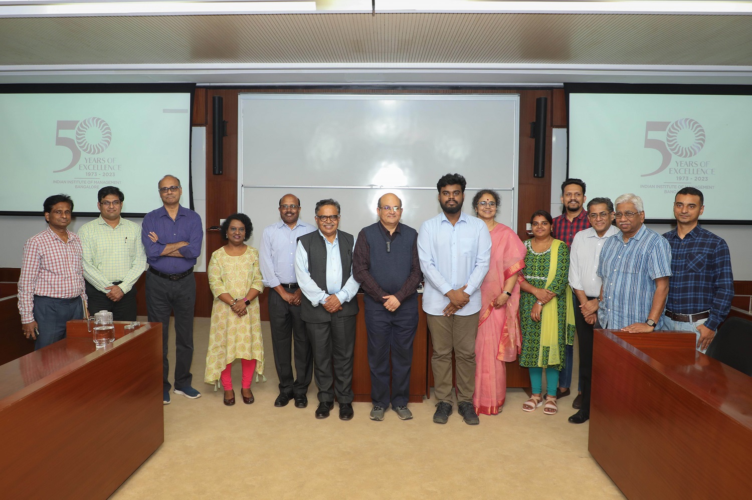 Prof. Rishikesha T Krishnan, Director, IIMB (seventh from left), with members of the faculty, staff and students at the Golden Jubilee logo launch event