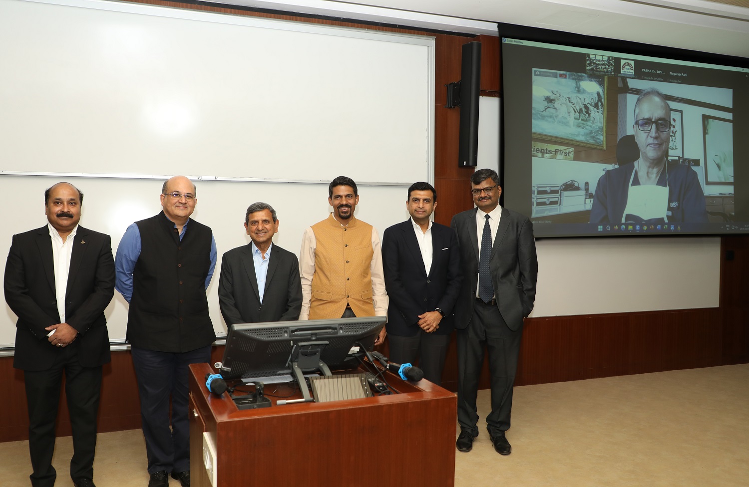 (L-R) Rajkiran Kanagala, Vice President and Group Head, Business Strategy, TCI, Prof. Rishikesha T Krishnan, Director, IIMB, Shri DP Agarwal, Chairman, TCI Group, Prof. Jitamitra Desai, Chairperson, Supply Chain Management Centre, Vineet Agarwal, MD, TCI Group, Dr Aditya Gupta, COO, SCMC at IIMB, Dr Devi Shetty, Chairman of the Board of Governors, IIMB( On Screen).