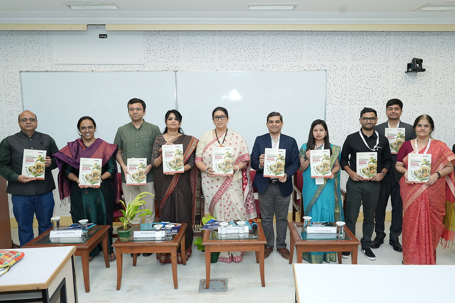 Stakeholders from IIM Bangalore, IIM Shillong, IIM Udaipur, the National Disease Modelling Consortium (NDMC) at IIT Bombay, Indian Council of Medical Research (ICMR), alongside Chief Guests Dr. Sanghamitra Pati and Ms. Smriti Zubin Irani, release the ‘Healthcare at Your Doorstep: The Promise of Ayushman Aarogya Mandirs’ report, prepared by IIM Bangalore in collaboration with IIM Udaipur, IIM Shillong and IIM Ranchi, during the Emerging Perspectives in Health Policy and Healthcare (EPHP) Conference 2026 hosted at IIMB.