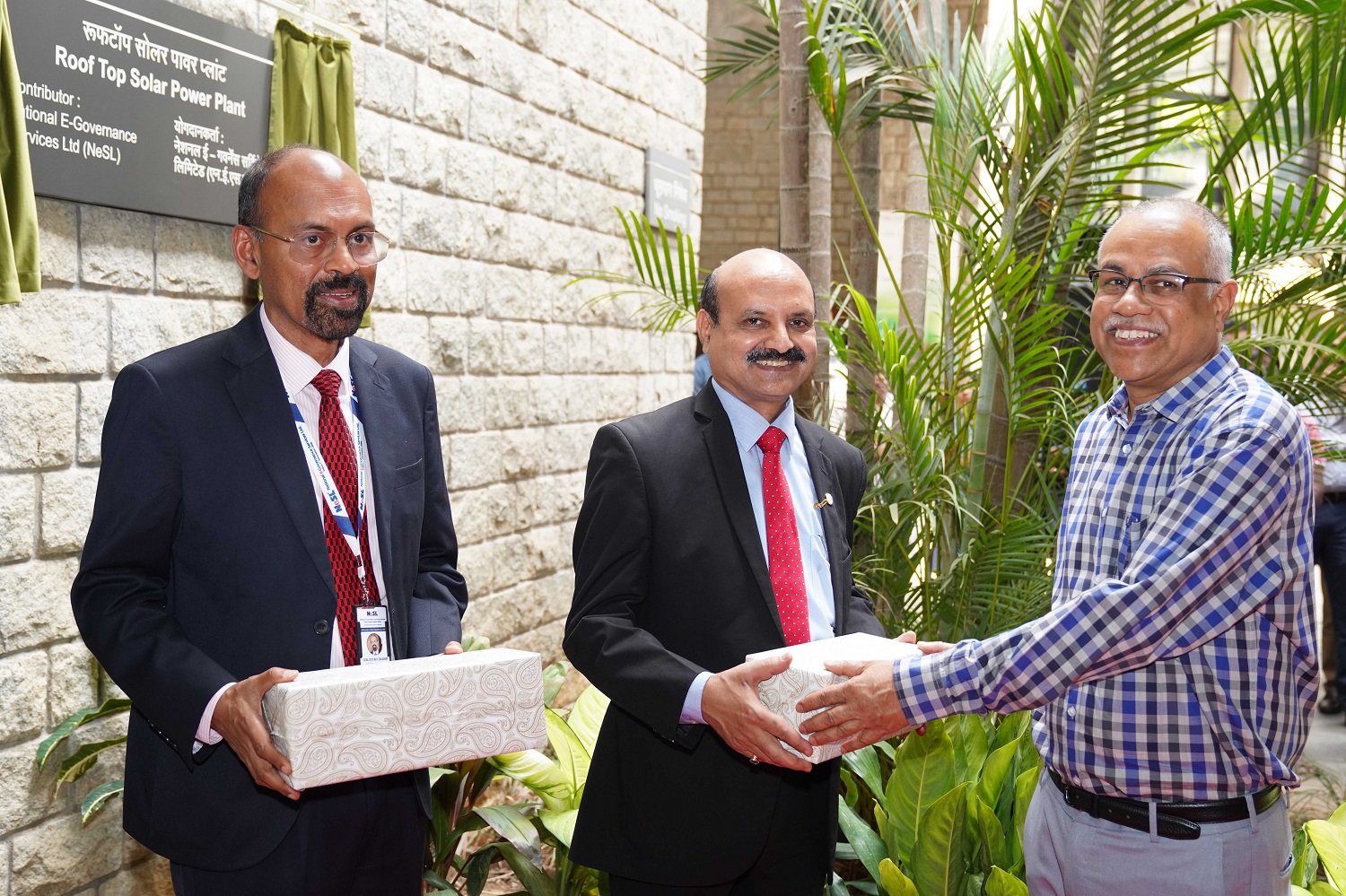 Prof. M Jayadev hands over tokens of appreciation to Ashok Chandra, Executive Director, Canara Bank, and Debajyoti Ray Chaudhuri, MD and CEO, National E-Governance Services Ltd. 