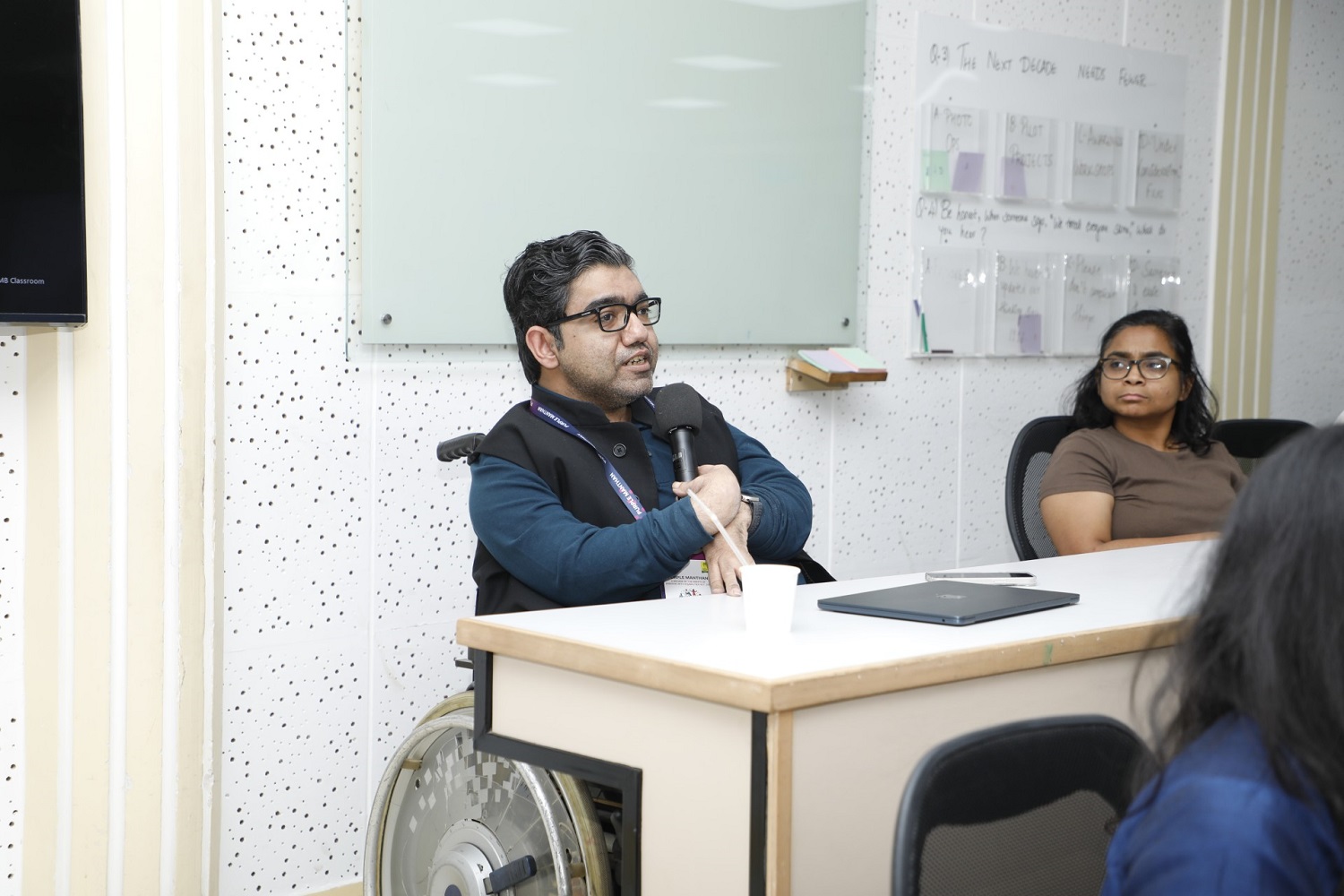 A participant engaged during the session at Purple Manthan, hosted by IIM Bangalore and the Association of People with Disability, contributing to the dialogue on disability-inclusive development.