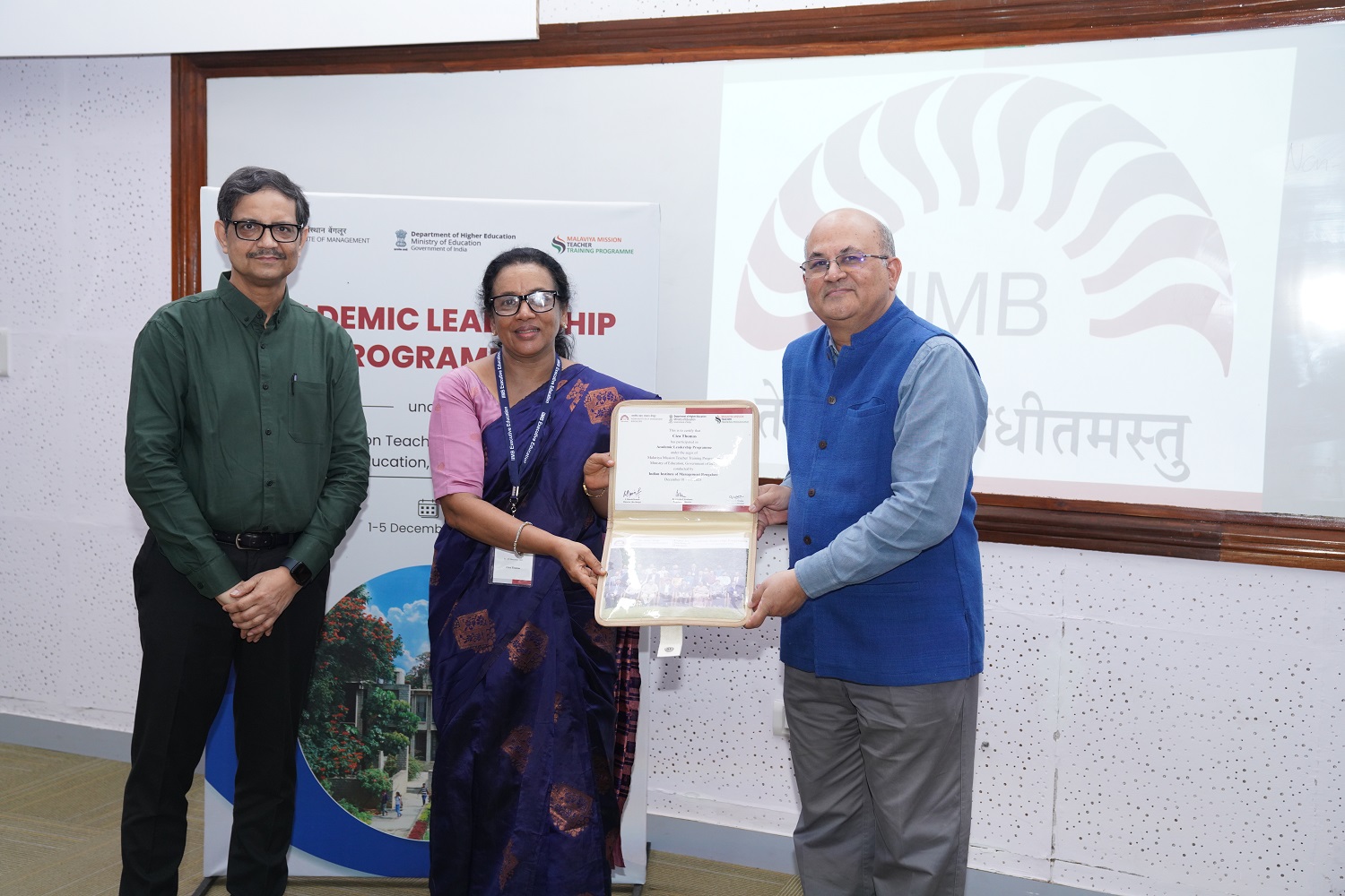 The Programme Directors, Prof. Sushanta Kumar Mishra, Chairperson, Centre for Teaching & Learning and faculty of the Organizational Behavior & Human Resources Management area, and Prof. Rishikesha T Krishnan, Professor In-charge, New Campus, and faculty of the Strategy area, with a programme participant during the Valedictory Ceremony.