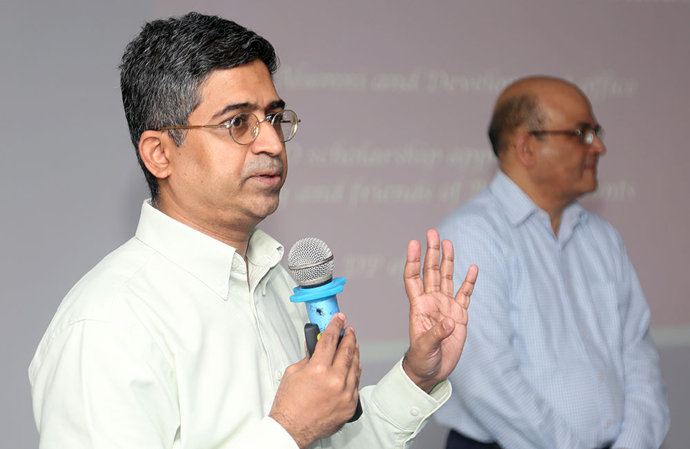 Professor Ananth Krishnamurthy, Chairperson, Doctoral Programme at IIMB, invites PhD students to the scholarship announcement programme on October 12, 2022. IIMB Director Prof. Rishikesha T Krishnan looks on.