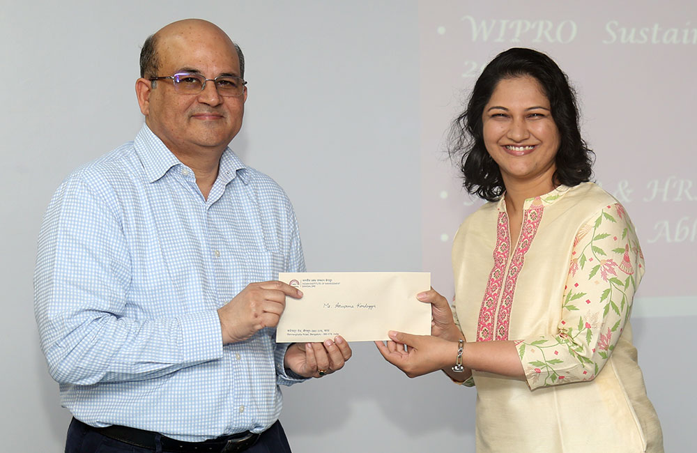 Anupama Kondayya, PhD scholar from the Organizational Behavior & Human Resources Management area, receives the WIPRO Sustainability Fellowship 2022 from Professor RT Krishnan.