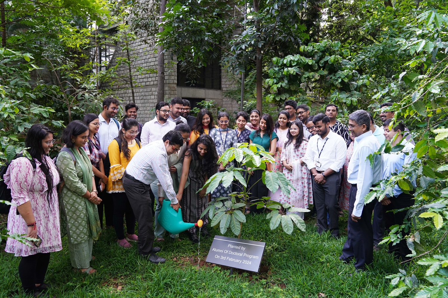 The incoming PhD batch students watered a tree planted by alumni of the PhD program, symbolizing strong roots and new shoots. 